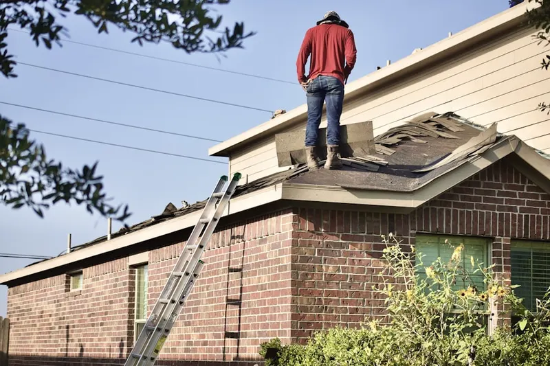 Professional roofer working on a residential roof in East Los Angeles